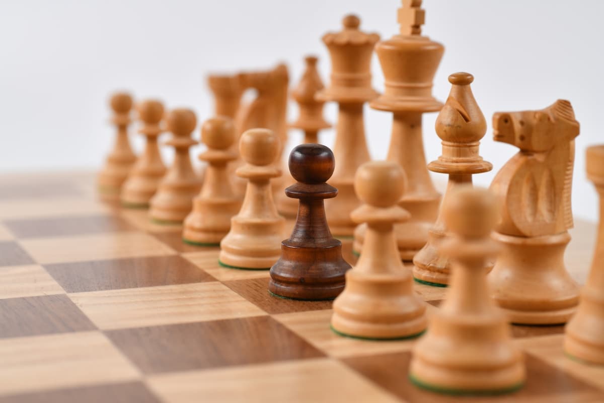 Chess pieces on a board, evoking rules and fair play